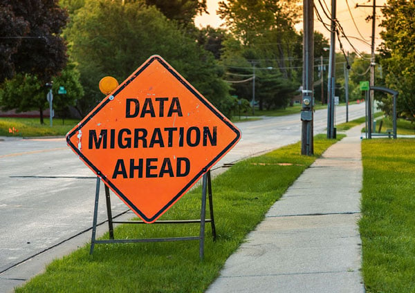 Orange road sign that says "Data Migration Ahead"