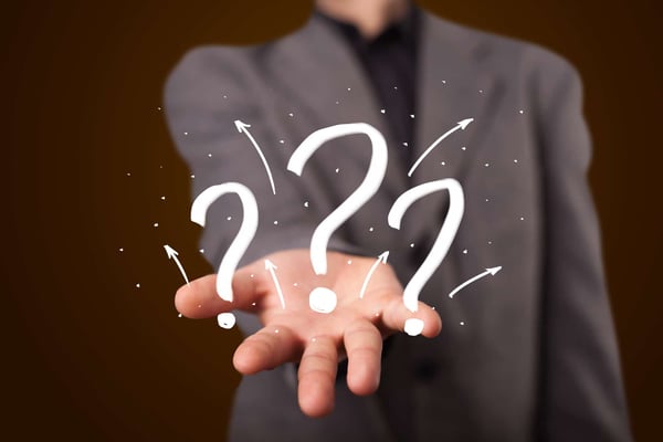 stockfresh_3783340_young-businessman-presenting-hand-drawn-question-marks_sizeM