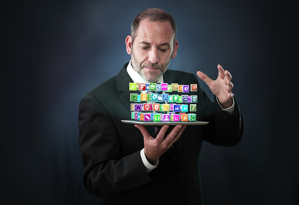 Magician Holding Tablet with ERP Consulting Apps