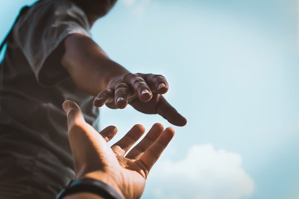 Person reaching out to another persons hand