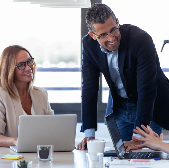 smiling-businessman-talking-with-colleagues-in-the-MSKWFVZ