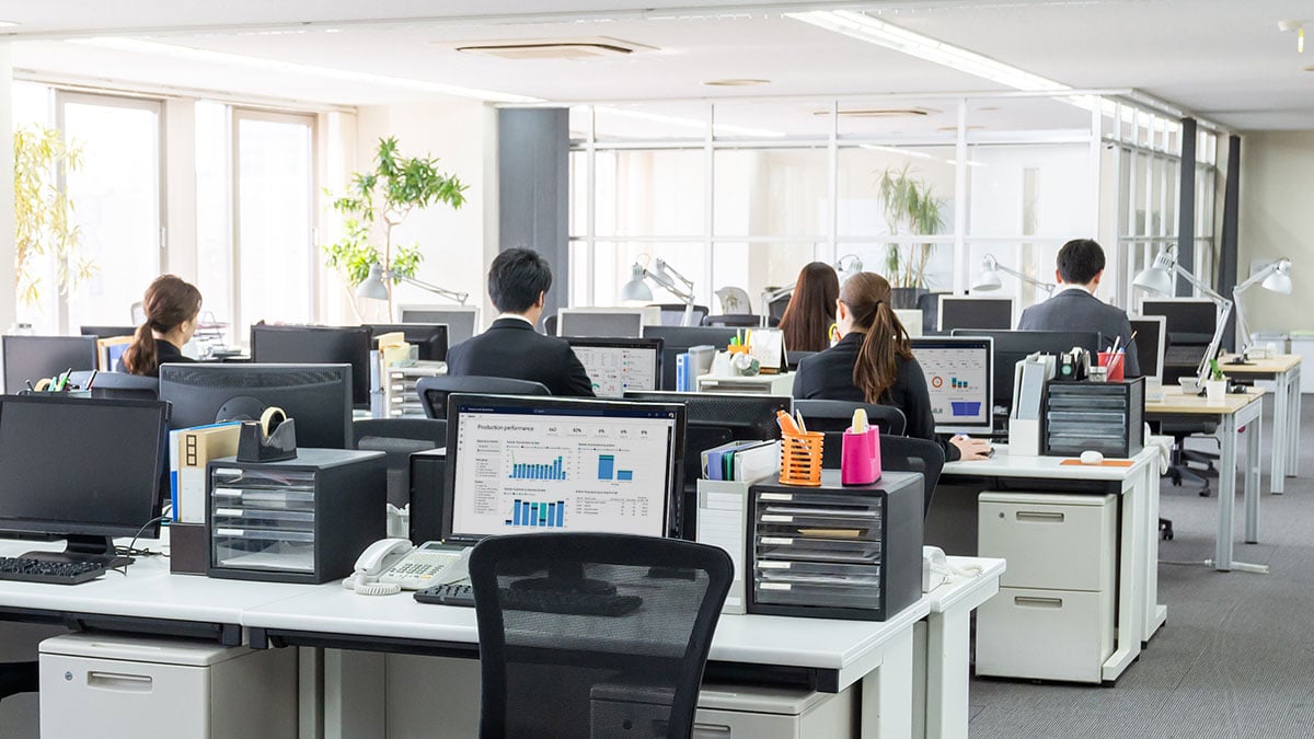 A group of people working on computers in a professional environment