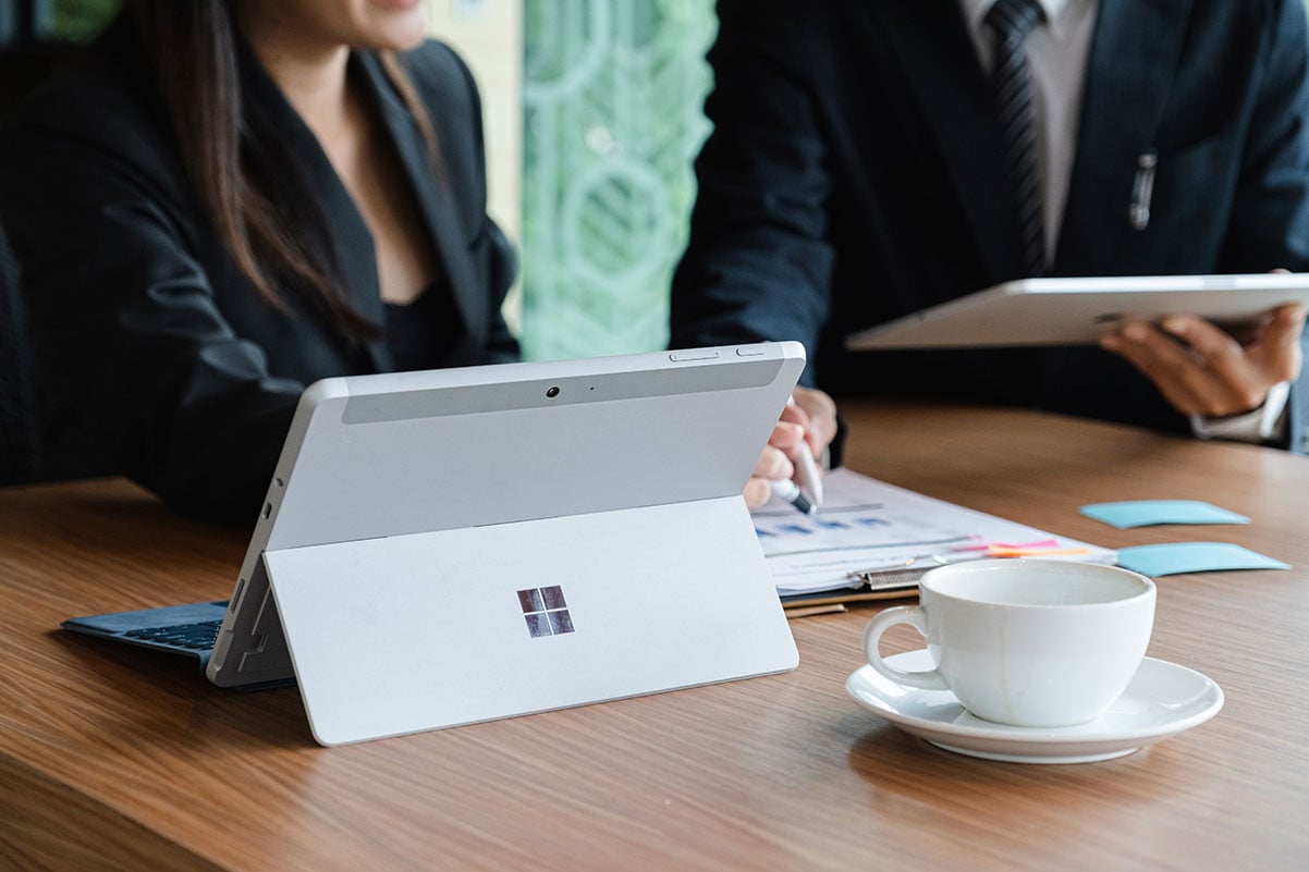 Two people working on their Microsoft Tablets